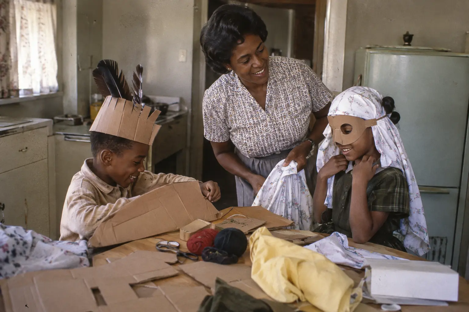 A family making Halloween costumes at a 1970s American kitchen table