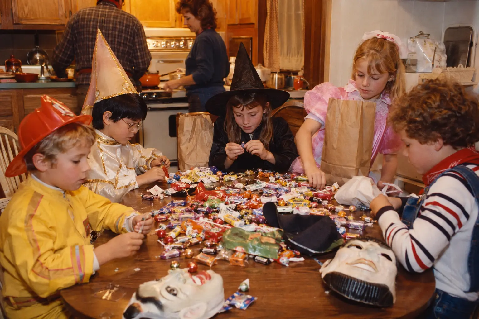 Children sorting unbranded Halloween candy after returning to an early 1980s kitchen