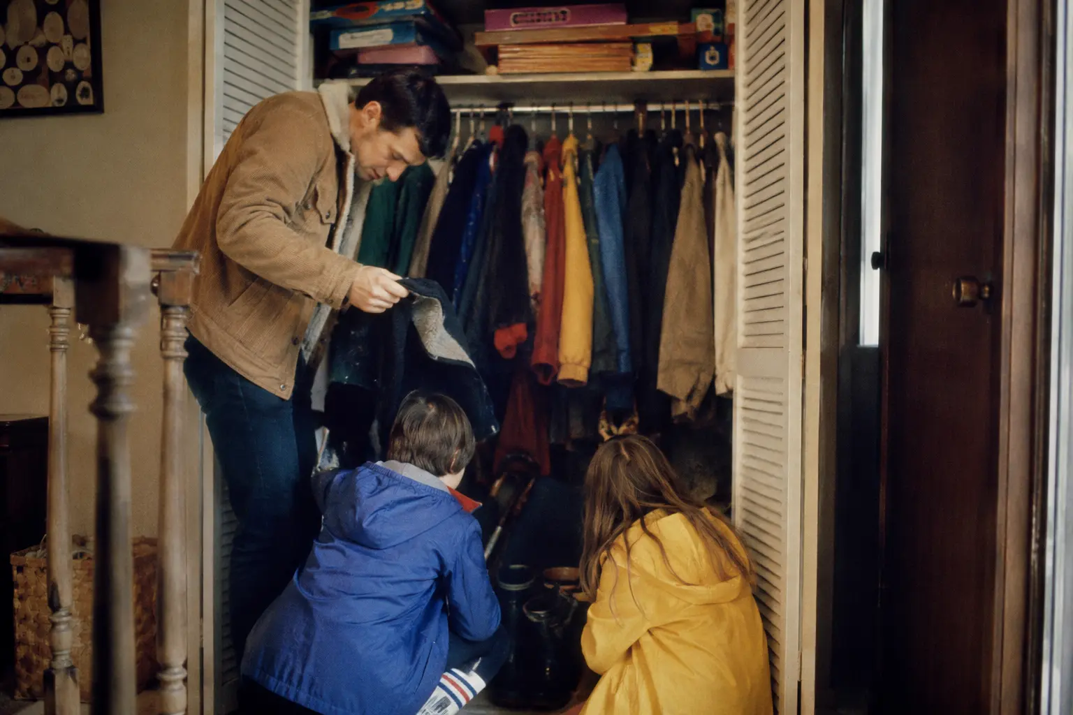 A crowded hallway closet in an American family home during the 1970s
